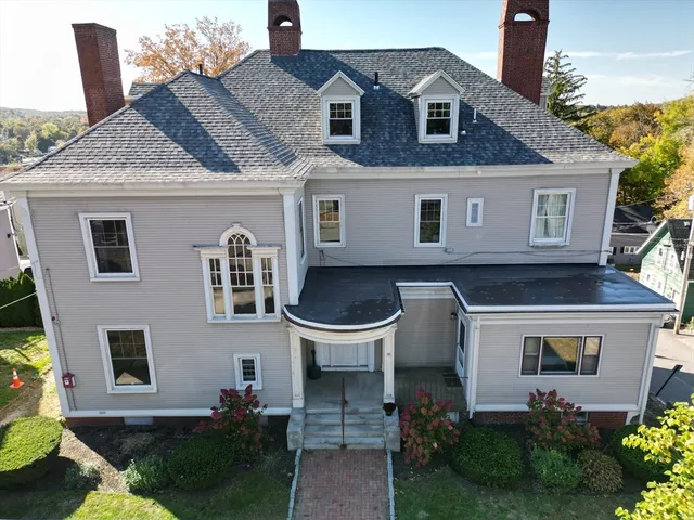 a aerial view of a house with a yard balcony and furniture