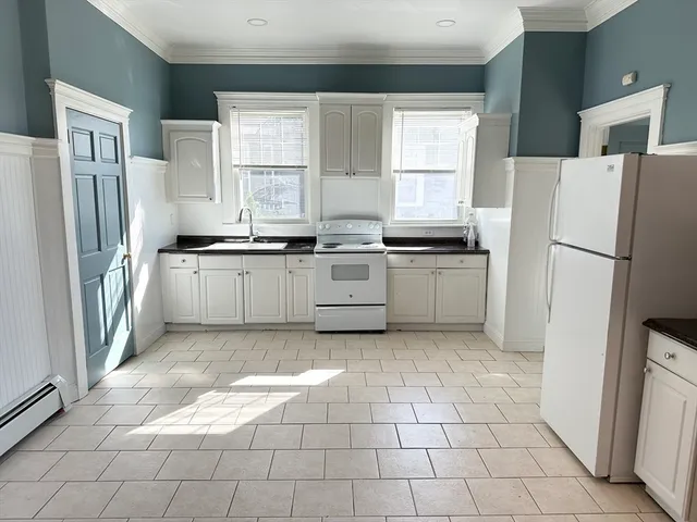 a kitchen with stainless steel appliances granite countertop a refrigerator sink and stove