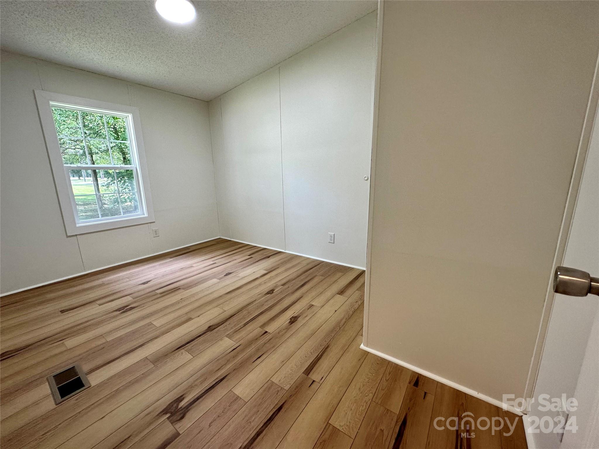 6686 Old Plank Road Stanley, NC 28164 - Photo 16 of 17 an empty room with windows