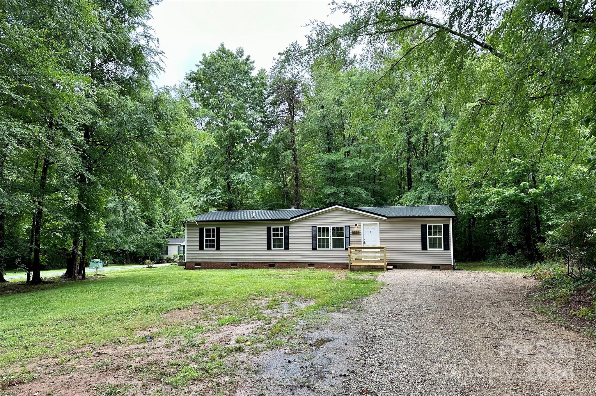 6686 Old Plank Road Stanley, NC 28164 - Photo 17 of 17 a front view of house with yard and green space