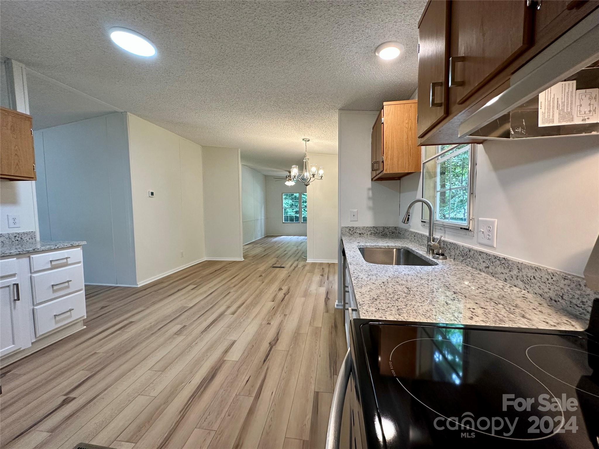 6686 Old Plank Road Stanley, NC 28164 - Photo 2 of 17 a kitchen with stainless steel appliances granite countertop a sink stove and cabinets