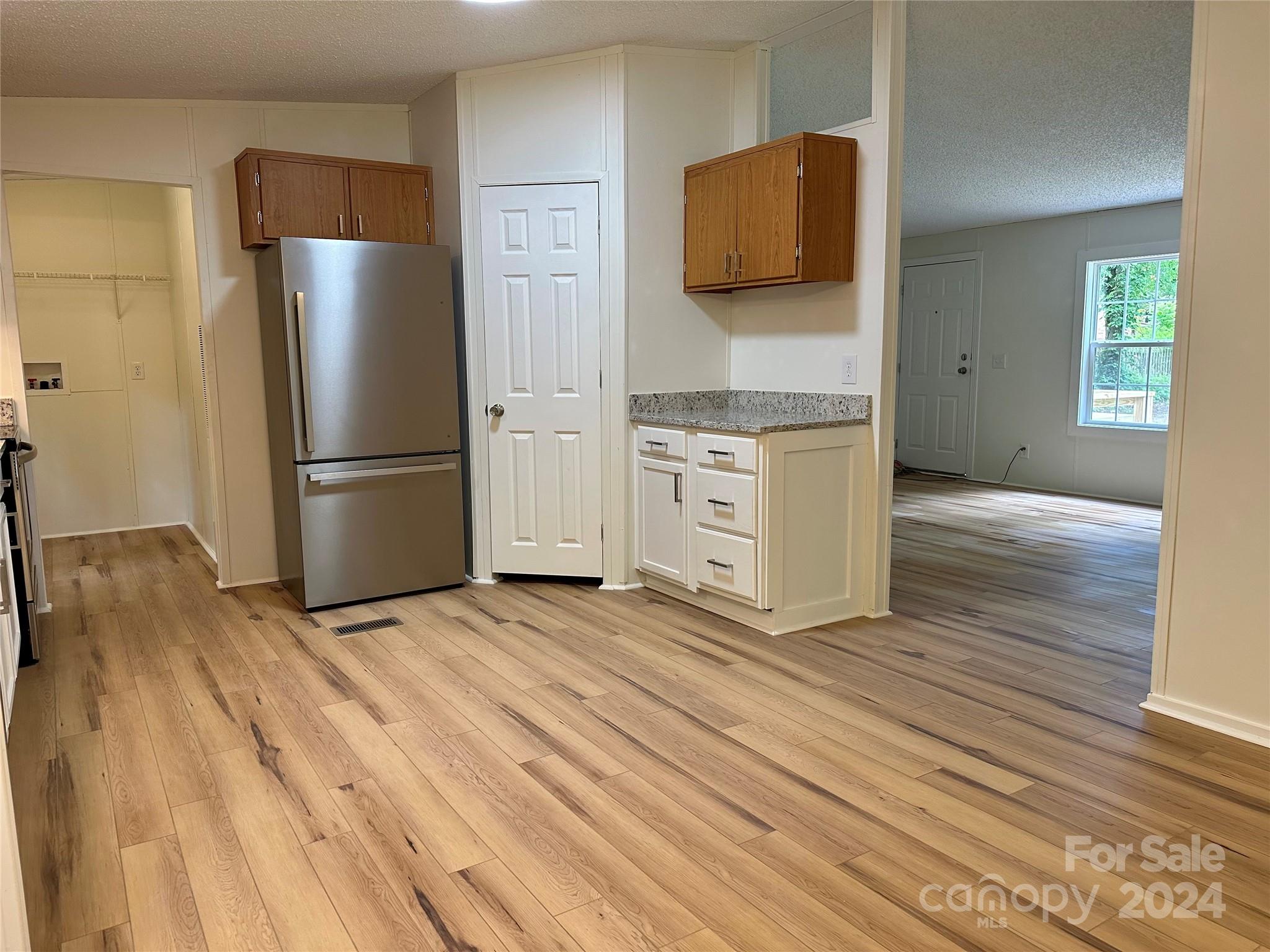 6686 Old Plank Road Stanley, NC 28164 - Photo 3 of 17 a kitchen with a refrigerator and a stove top oven