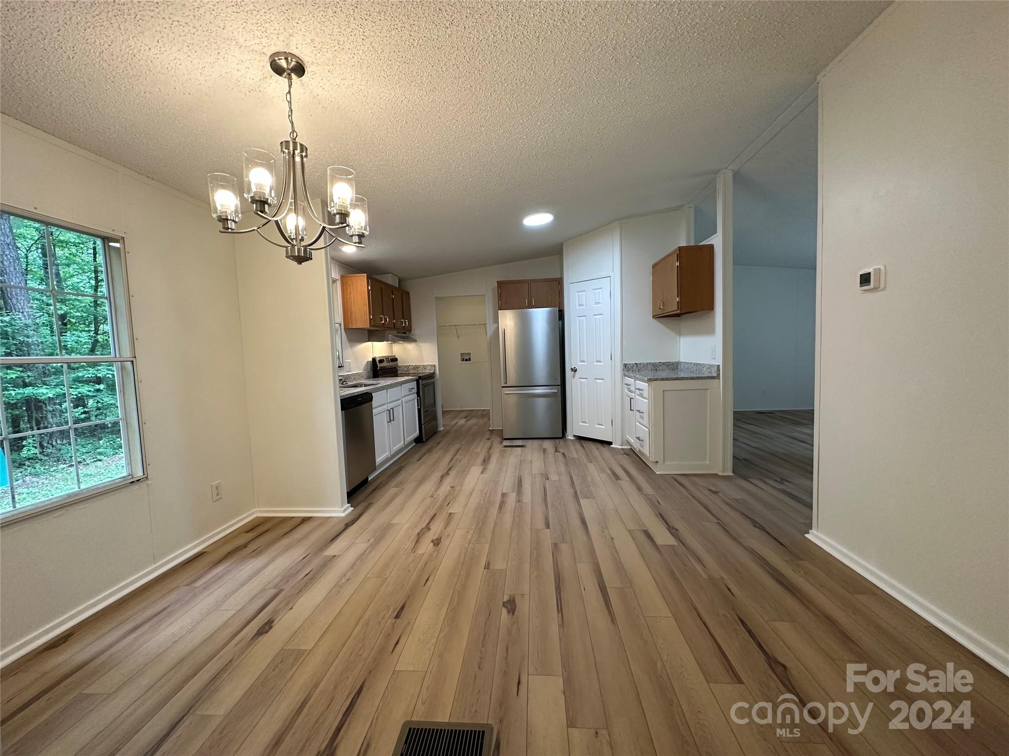 6686 Old Plank Road Stanley, NC 28164 - Photo 4 of 17 a view of a house with wooden floor and a kitchen