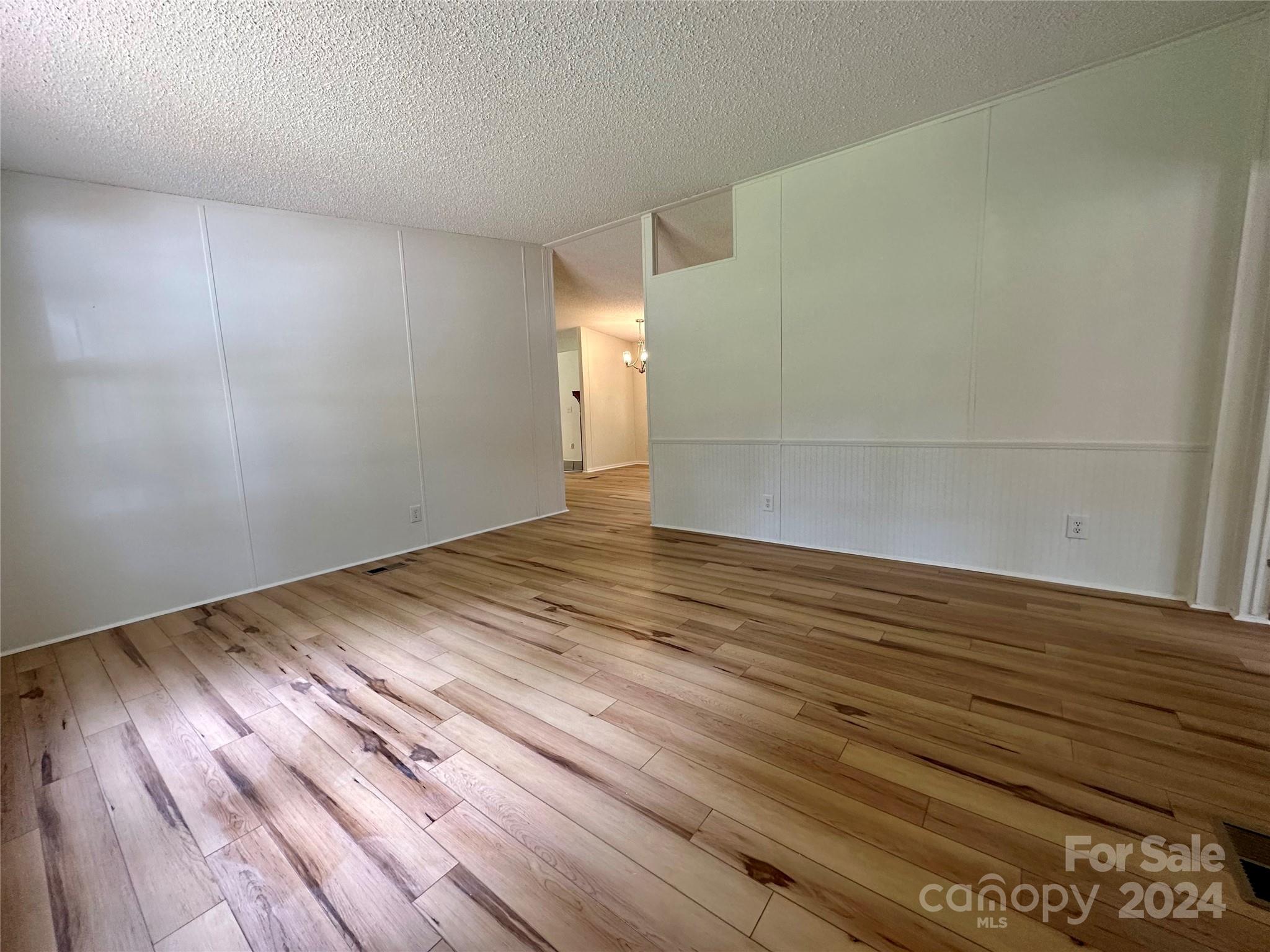 6686 Old Plank Road Stanley, NC 28164 - Photo 5 of 17 a view of empty room with wooden floor