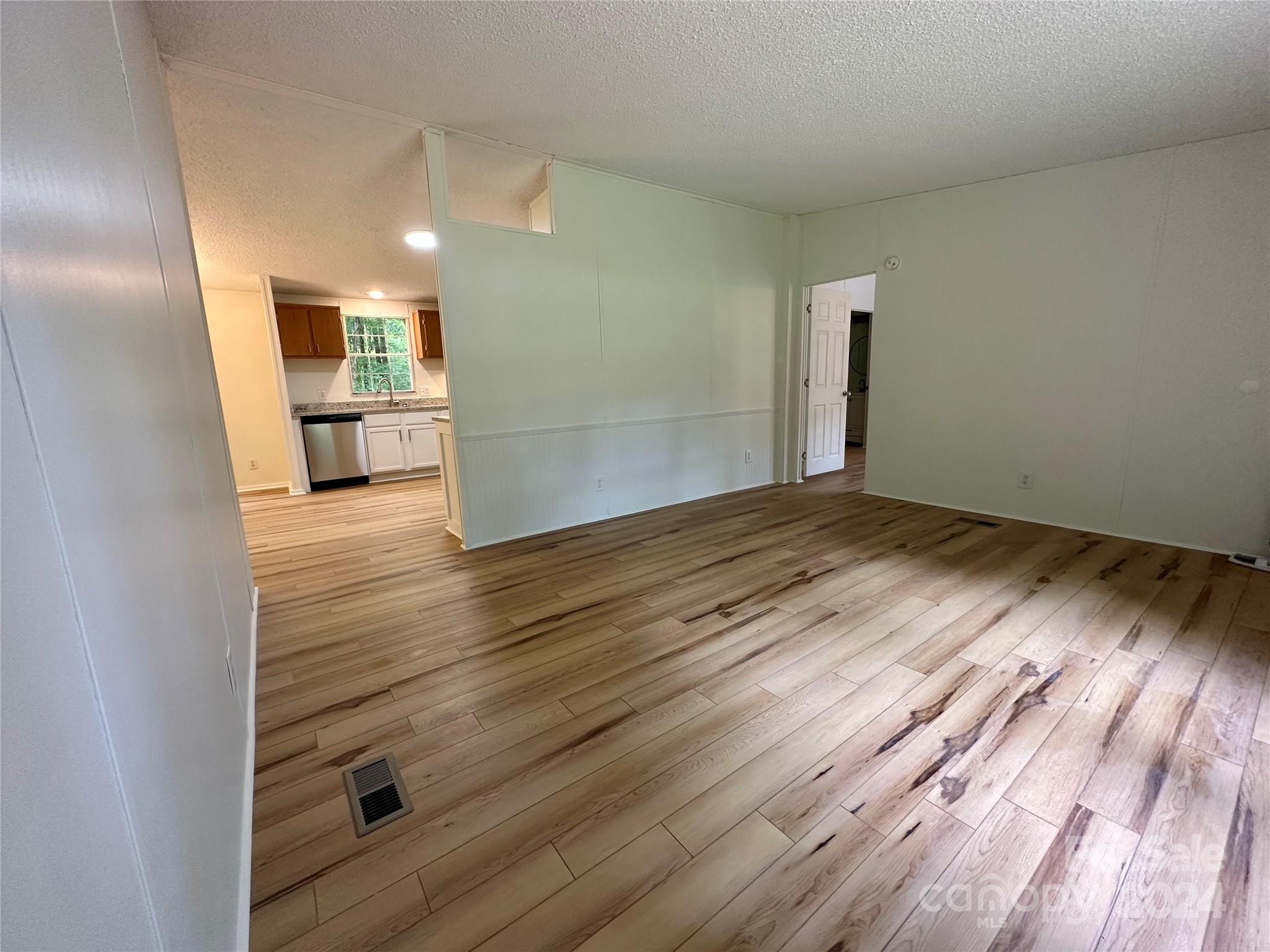 6686 Old Plank Road Stanley, NC 28164 - Photo 6 of 17 a view of a kitchen cabinets and wooden floor
