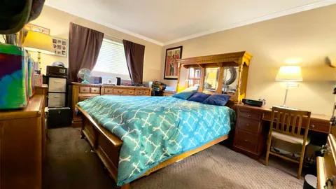 a bed sitting in a bedroom next to a window