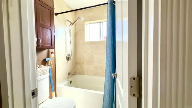 a bathroom with a shower and a bath tub