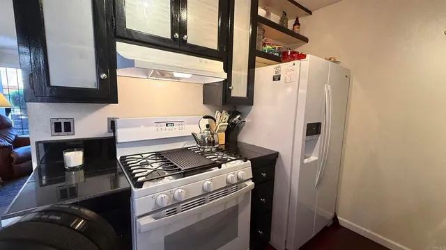 a kitchen with a stove and a refrigerator