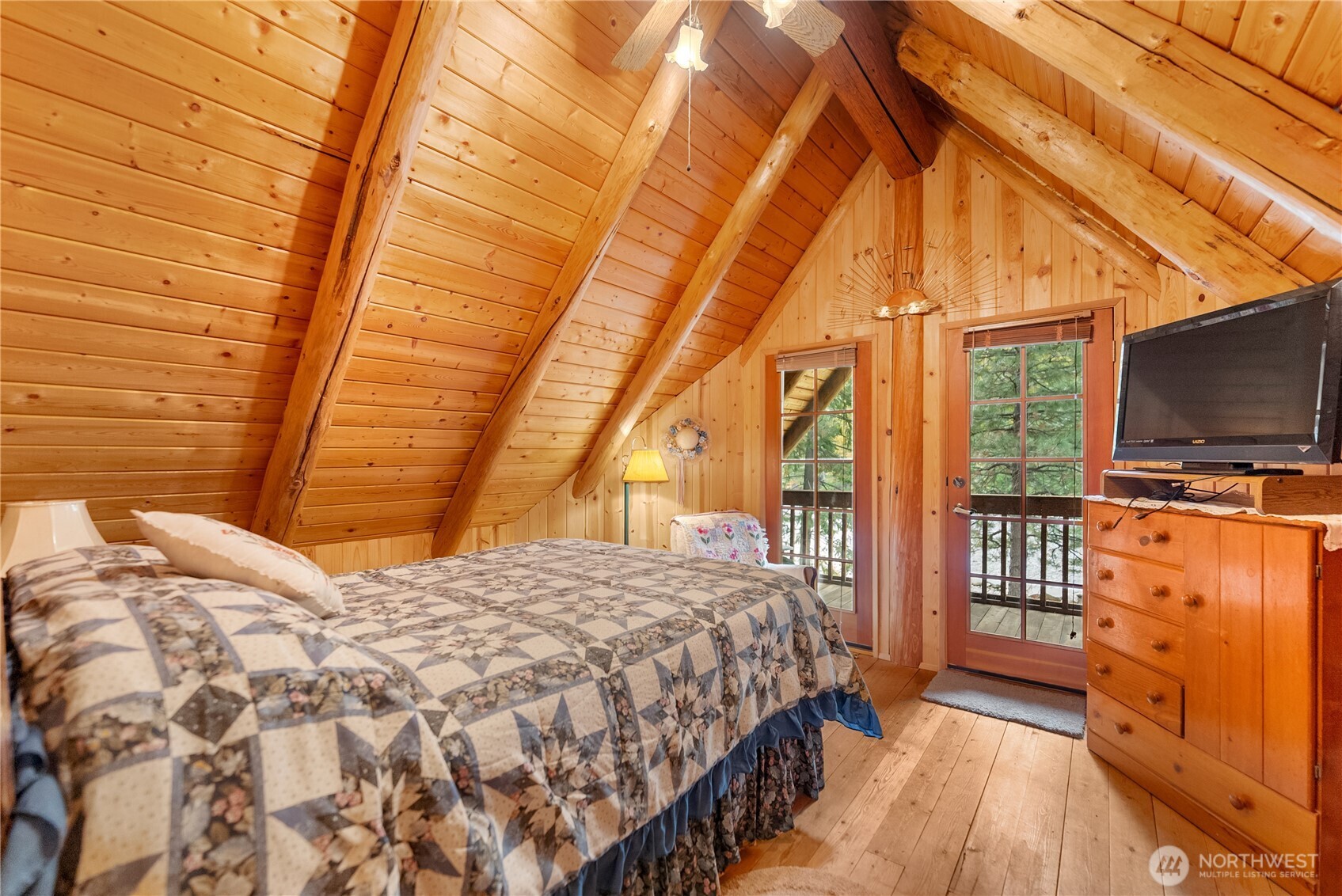 26 Mercer Road Mazama, WA 98833 - Photo 16 of 40 a bedroom with a bed and a flat tv screen