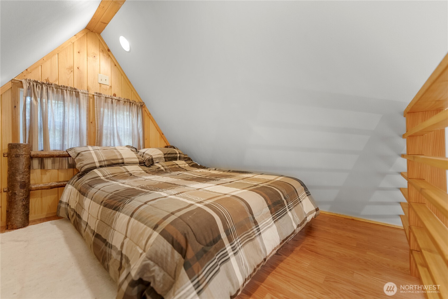 26 Mercer Road Mazama, WA 98833 - Photo 24 of 40 a bed sitting in a bedroom next to a bathroom