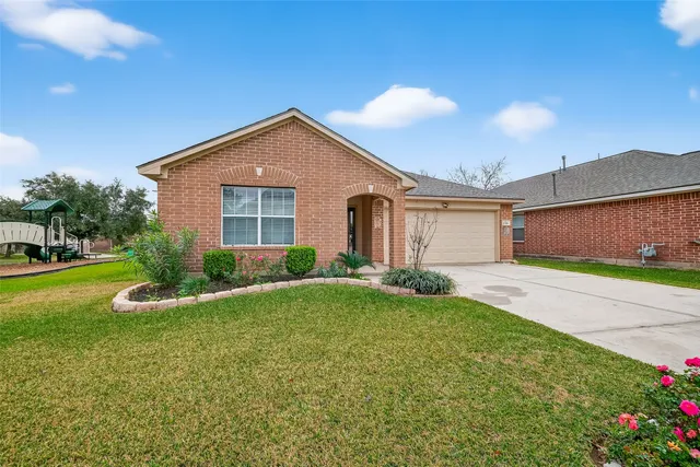 a view of a house with a yard and garage