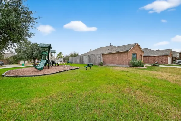 a front view of house with a garden and patio