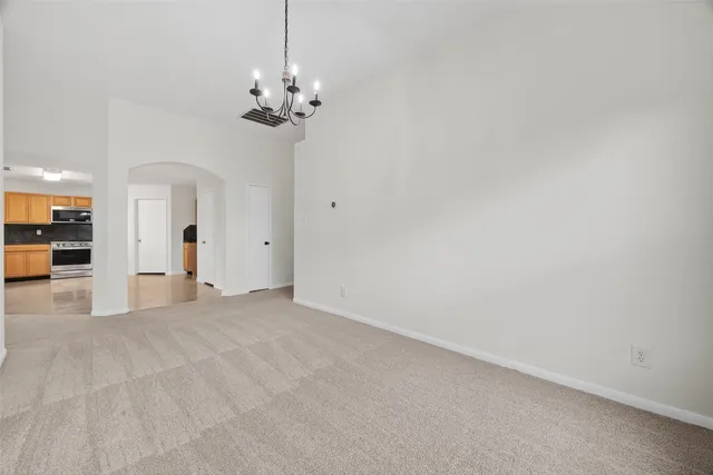 a view of a chandelier in big room and a chandelier fan