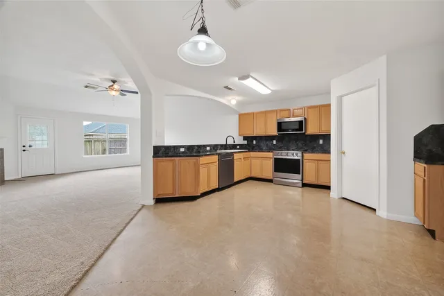 a view of a kitchen with a sink cabinets and window