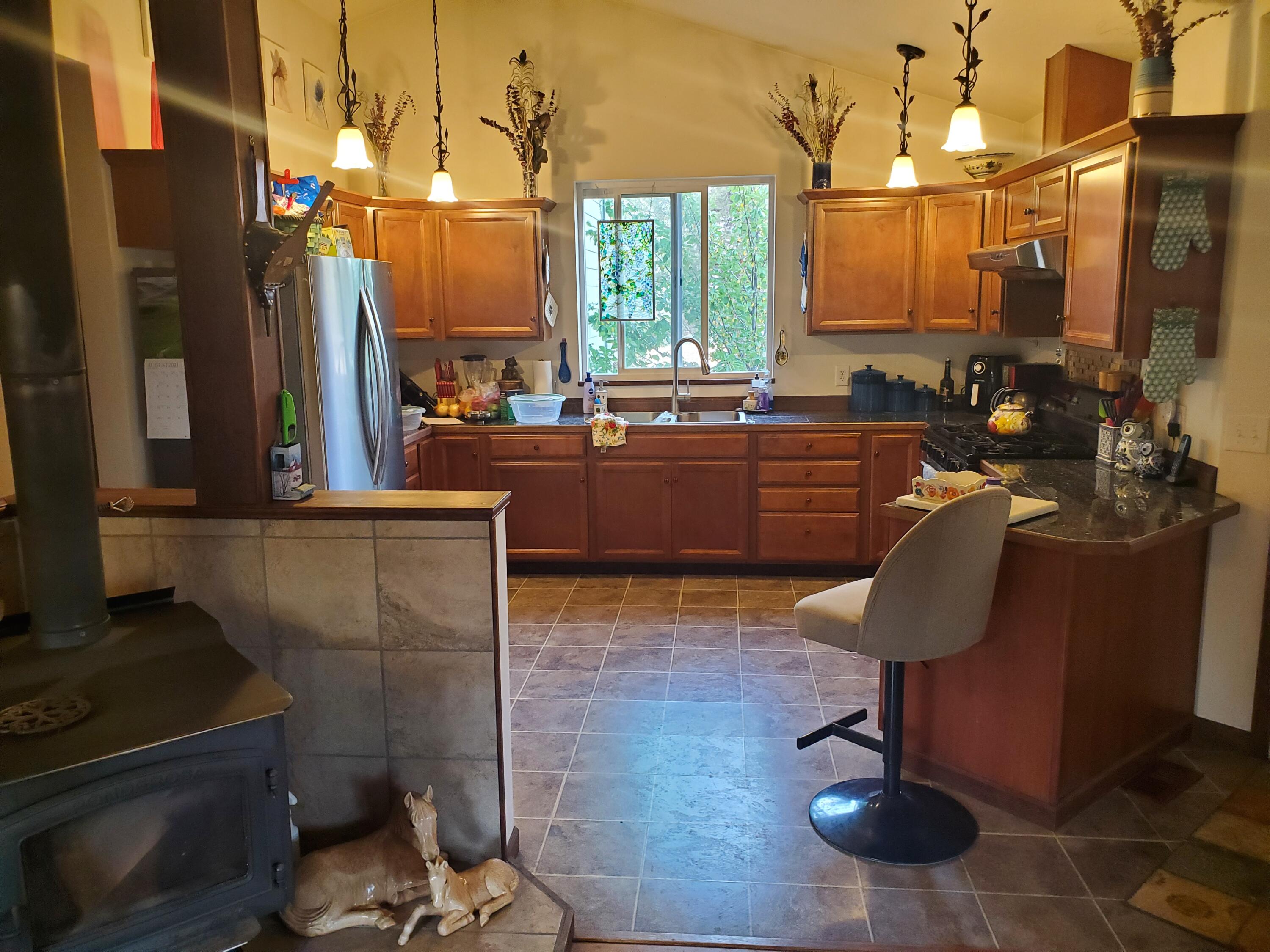 22915 Bliss Road Sprague River, OR 97639 - Photo 15 of 23 a kitchen with sink refrigerator and cabinets
