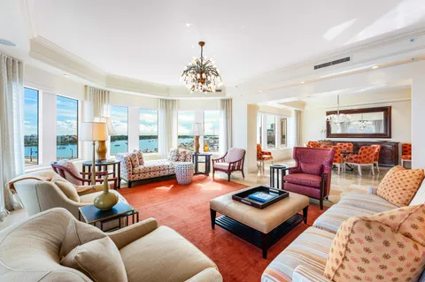 a living room with furniture large window and a table