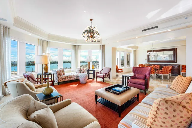 a living room with furniture large window and a table