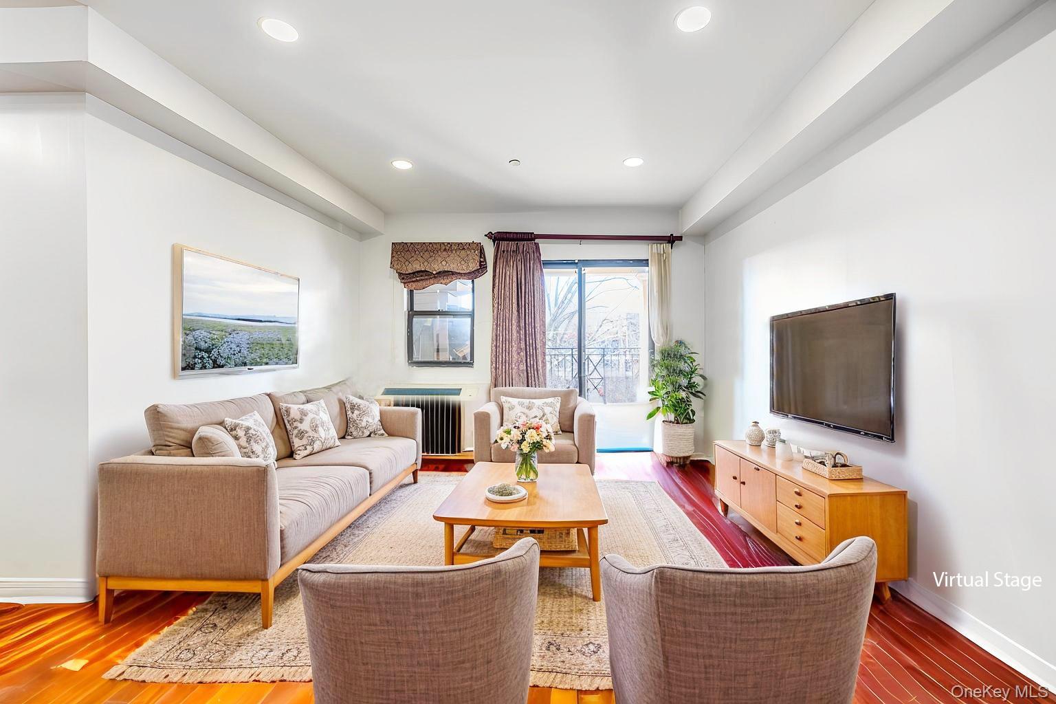 71-19 162nd Street, Unit 3D Queens, NY 11365 - Photo 3 of 14 Living room with radiator heating unit, dark wood-style floors, and recessed lighting