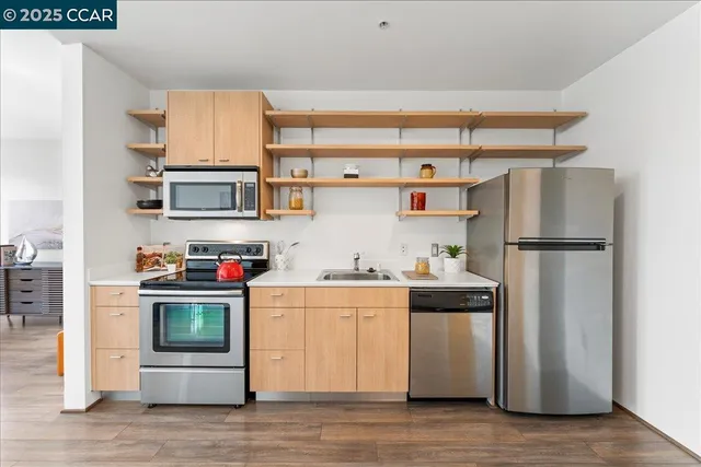 a kitchen with stainless steel appliances a refrigerator and a stove