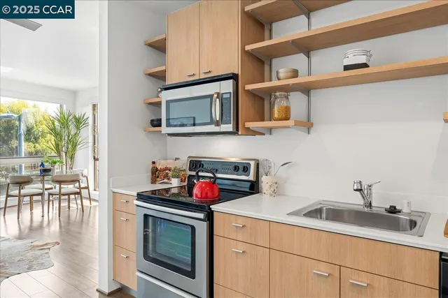a kitchen with cabinets a stove and a wooden floor