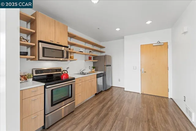 a kitchen with stainless steel appliances a stove a microwave and cabinets