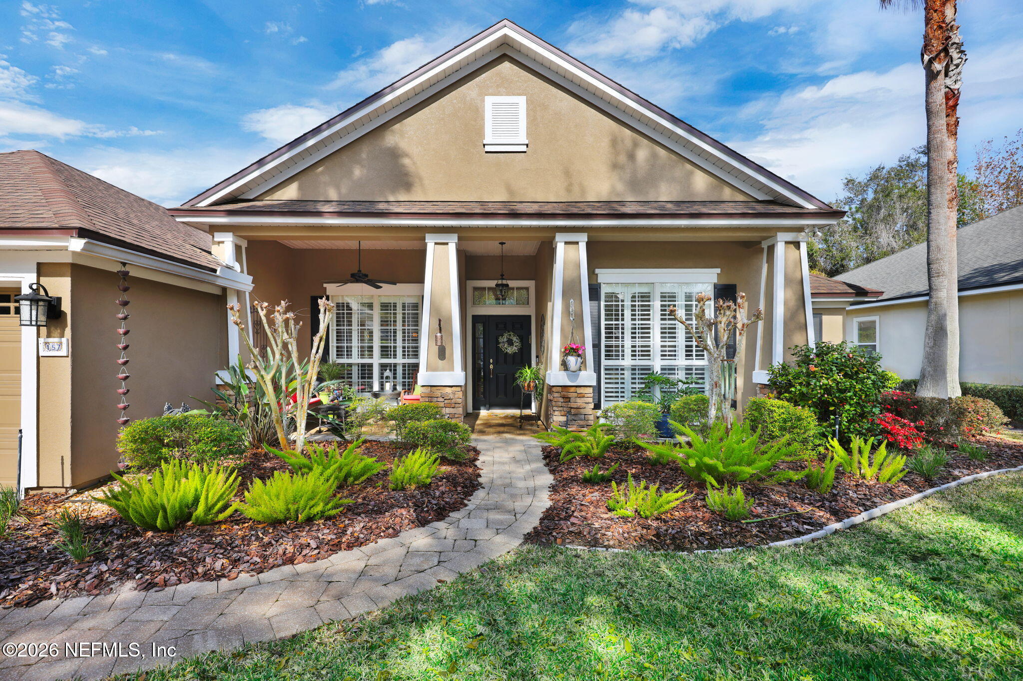 157 Oak Common Avenue St. Augustine, FL 32095 - Photo 1 of 57 a front view of a house with garden
