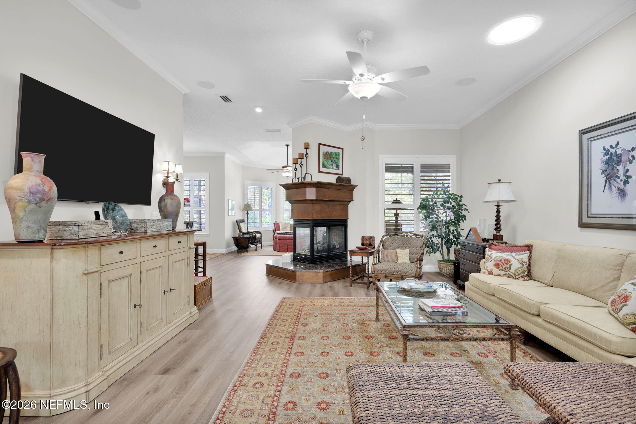 157 Oak Common Avenue St. Augustine, FL 32095 - Photo 12 of 57 a living room with furniture a fireplace and a flat screen tv