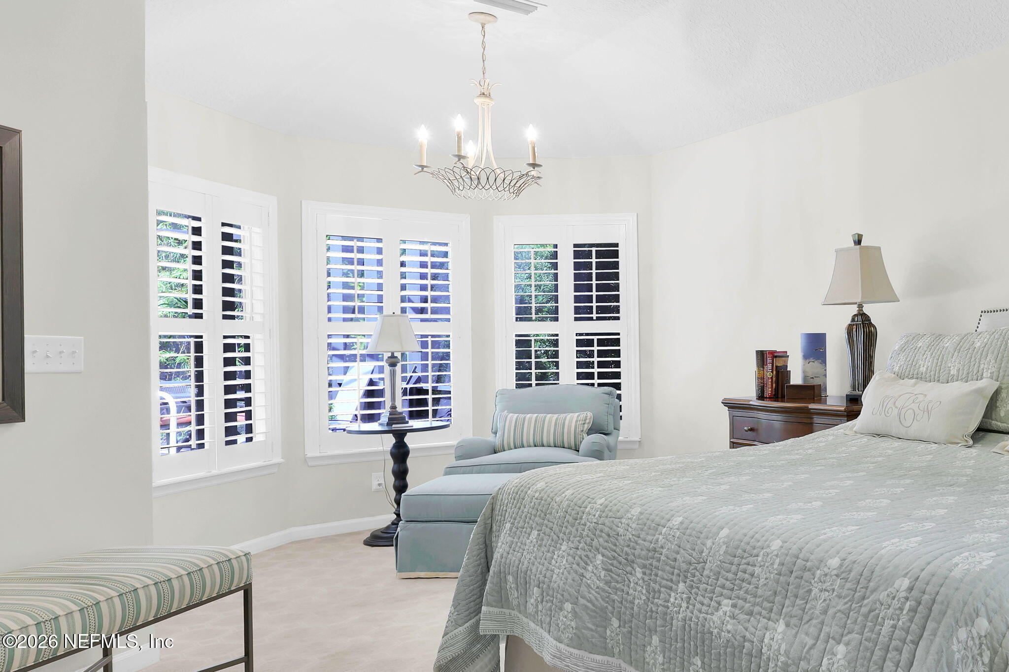 157 Oak Common Avenue St. Augustine, FL 32095 - Photo 25 of 57 a bedroom with a large bed and a chandelier