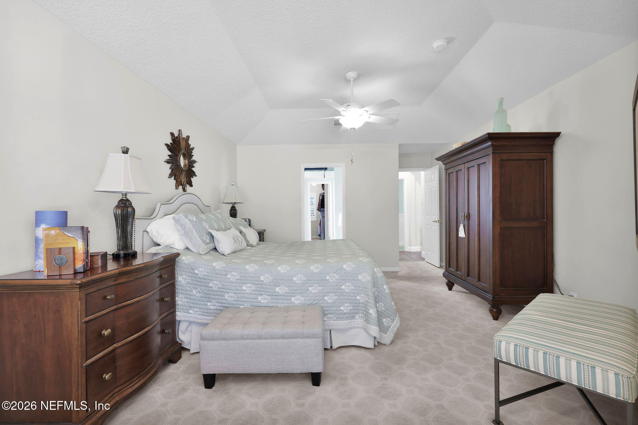 157 Oak Common Avenue St. Augustine, FL 32095 - Photo 26 of 57 a spacious bedroom with a bed and a chandelier