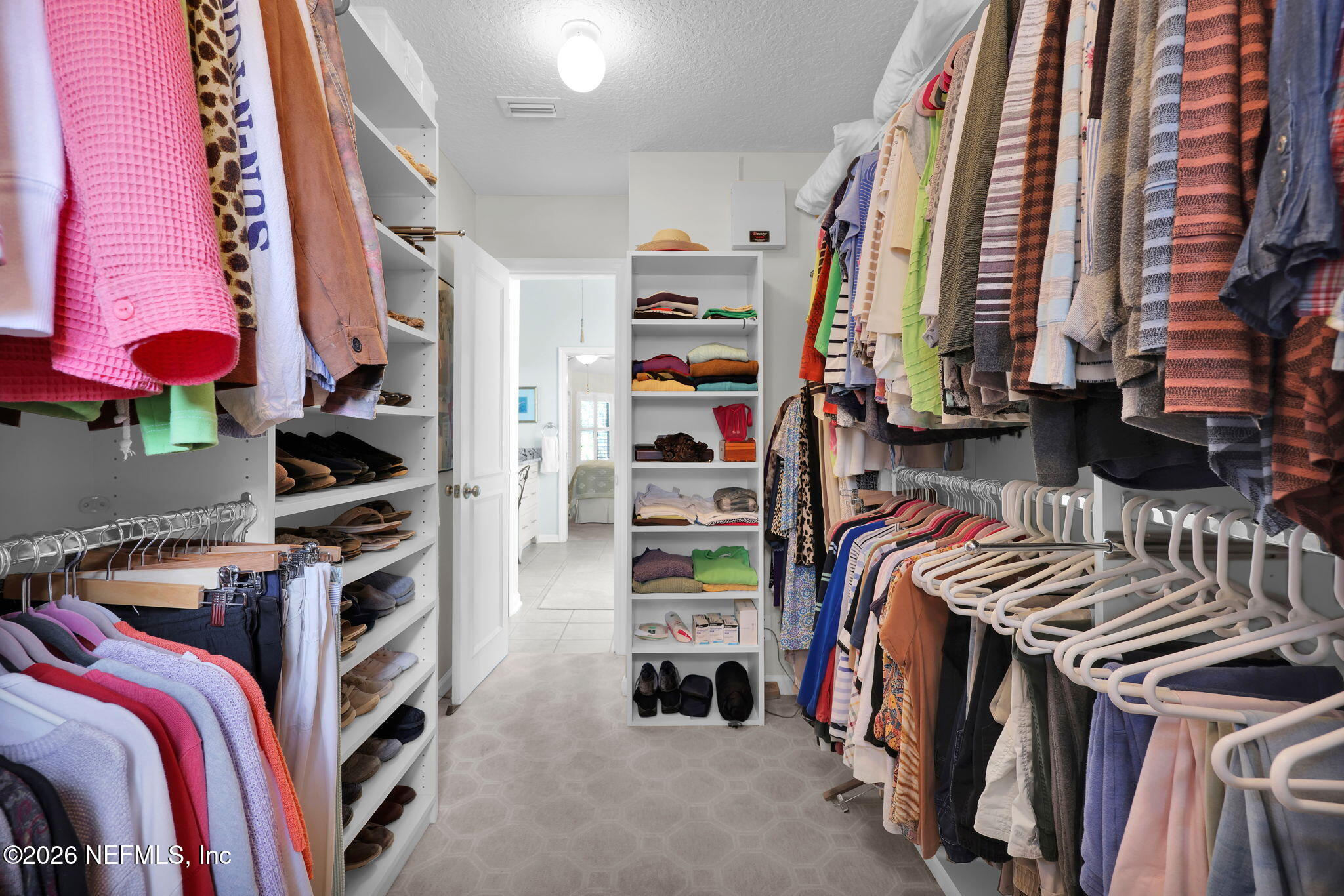 157 Oak Common Avenue St. Augustine, FL 32095 - Photo 30 of 57 a view of walk in closet with clothes and shoes