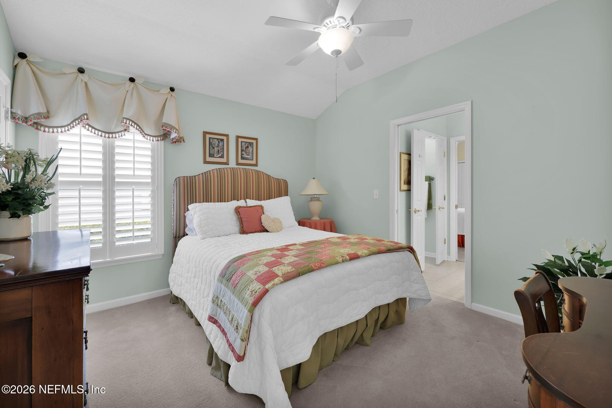 157 Oak Common Avenue St. Augustine, FL 32095 - Photo 31 of 57 a bedroom with a bed a chandelier and a window