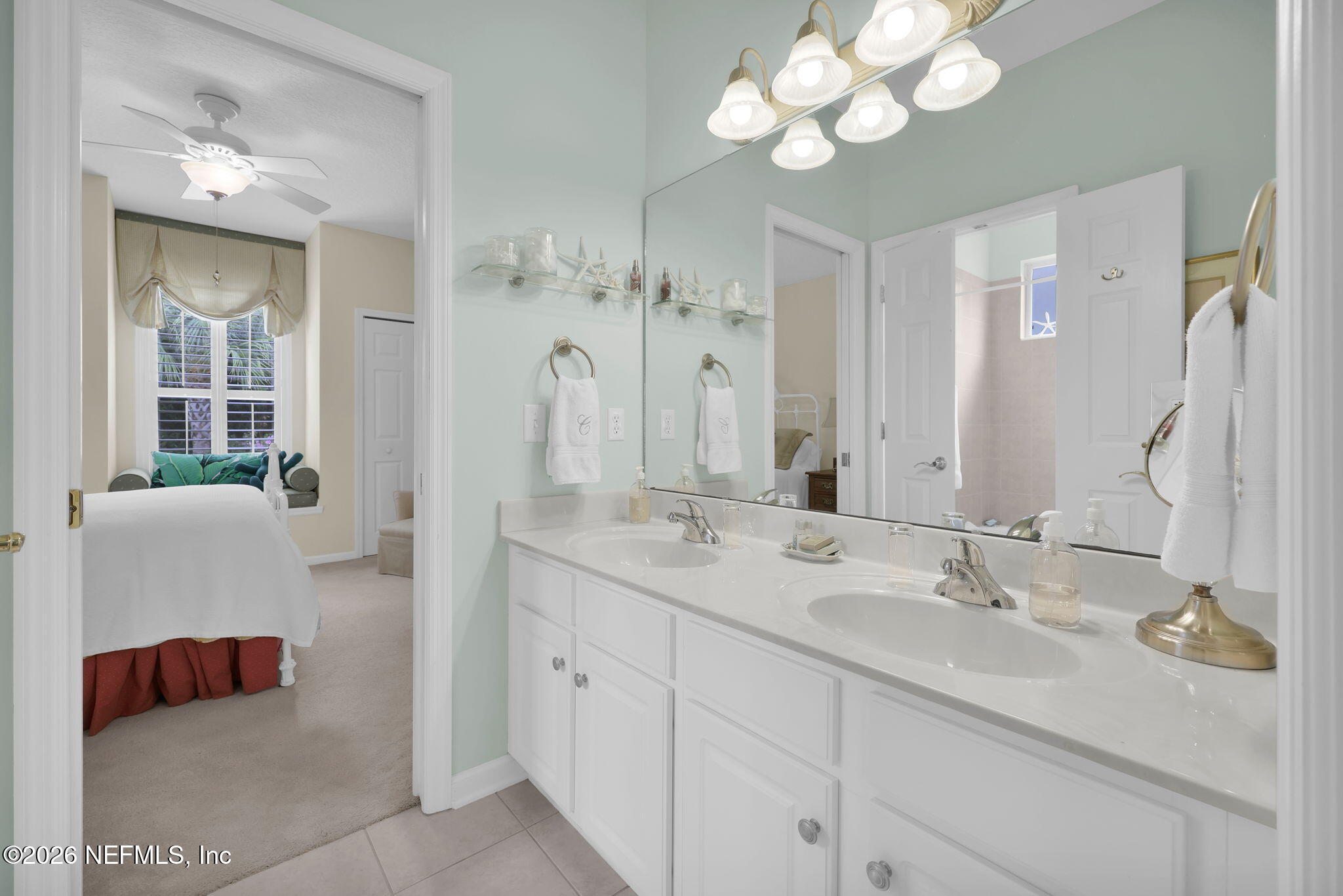 157 Oak Common Avenue St. Augustine, FL 32095 - Photo 32 of 57 a en suite bathroom with a double vanity sink and a mirror