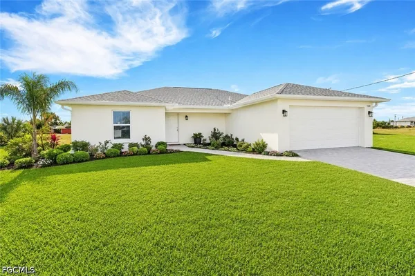 a front view of house with yard and green space