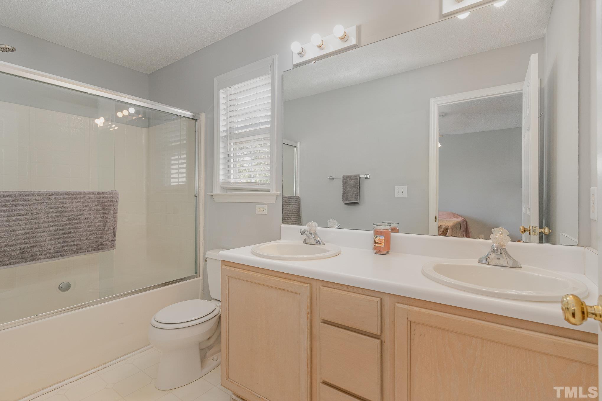 5339 Cog Hill Court Raleigh, NC 27604 - Photo 12 of 23 a bathroom with a sink a toilet and shower