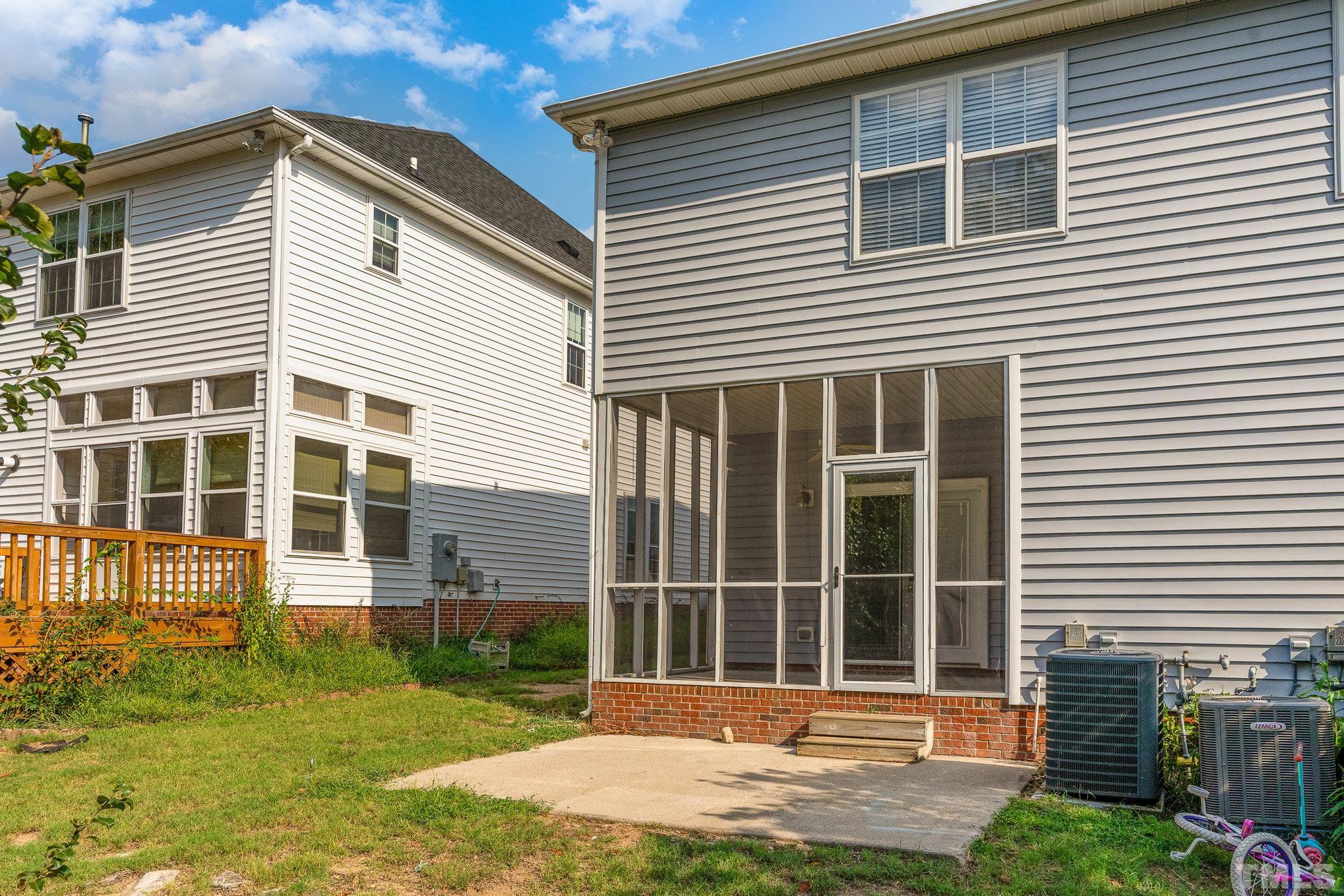 5339 Cog Hill Court Raleigh, NC 27604 - Photo 14 of 23 a front view of a house with a yard and glass windows
