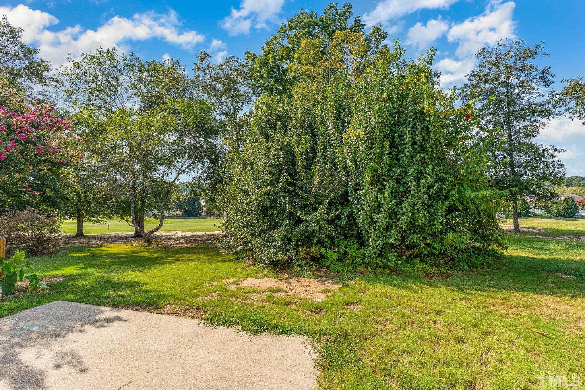 5339 Cog Hill Court Raleigh, NC 27604 - Photo 15 of 23 a view of a fountain in front of a house with a big yard and large trees