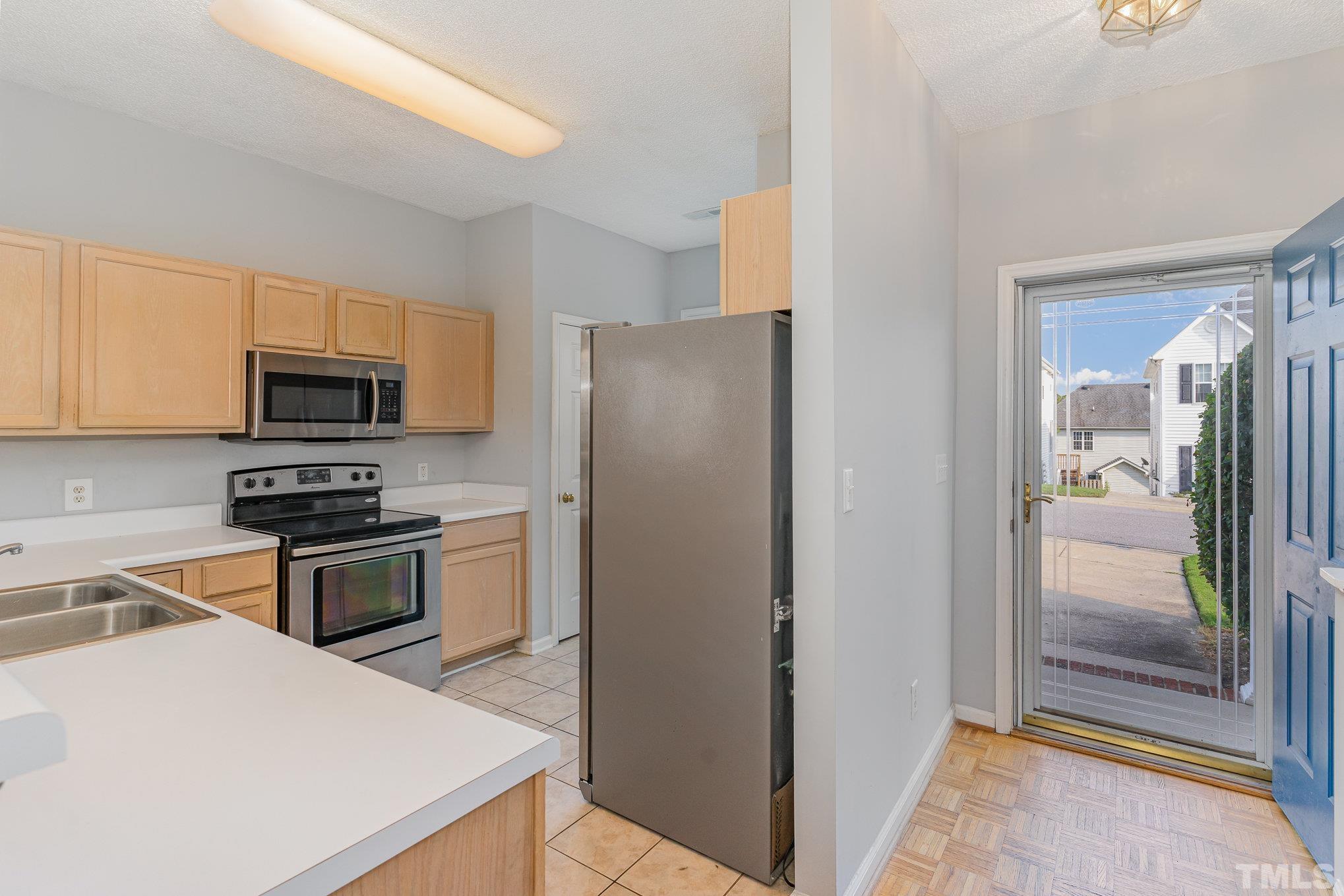 5339 Cog Hill Court Raleigh, NC 27604 - Photo 6 of 23 a kitchen with a refrigerator stove and microwave
