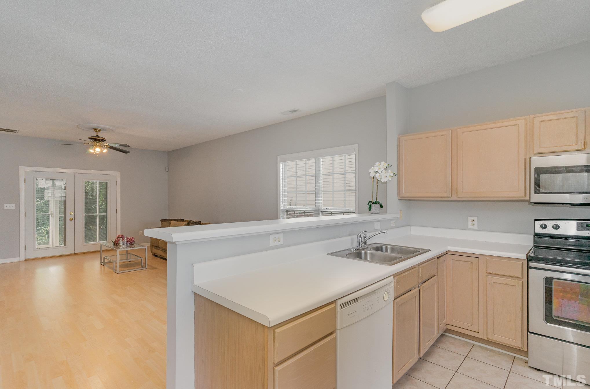 5339 Cog Hill Court Raleigh, NC 27604 - Photo 7 of 23 a kitchen that has a sink a stove and white cabinets