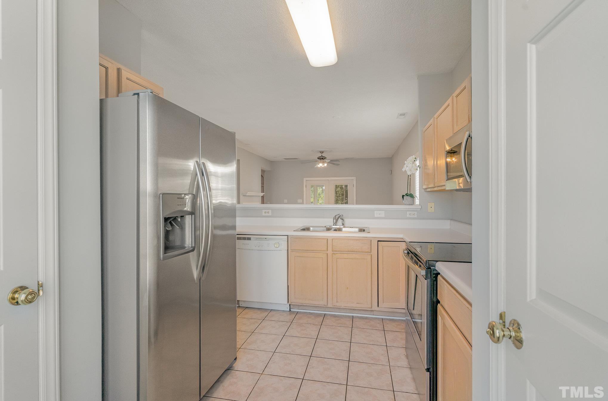 5339 Cog Hill Court Raleigh, NC 27604 - Photo 8 of 23 a kitchen with a refrigerator sink and cabinets