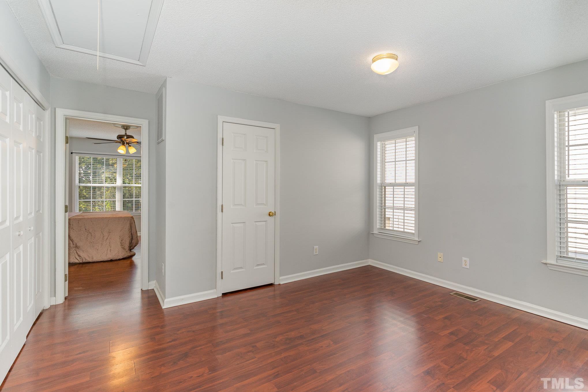 5339 Cog Hill Court Raleigh, NC 27604 - Photo 9 of 23 an empty room with wooden floor and windows