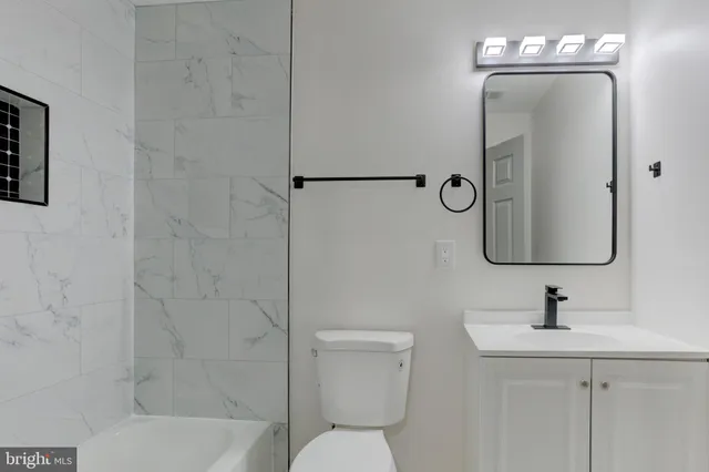 a bathroom with a toilet sink and shower