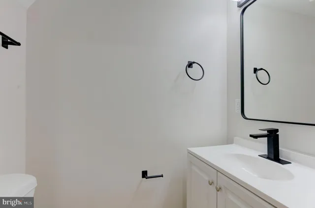a kitchen with kitchen island white cabinets and refrigerator