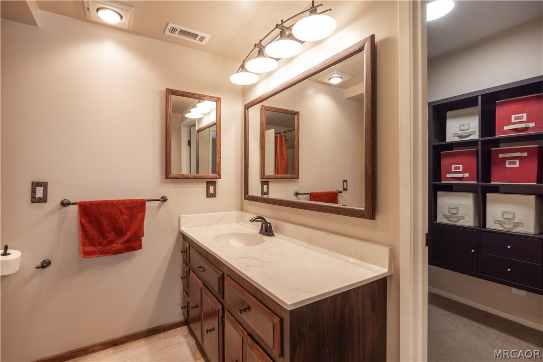 773 Sunset Lane Sugarloaf, CA 92386 - Photo 13 of 33 a bathroom with a sink vanity and a mirror
