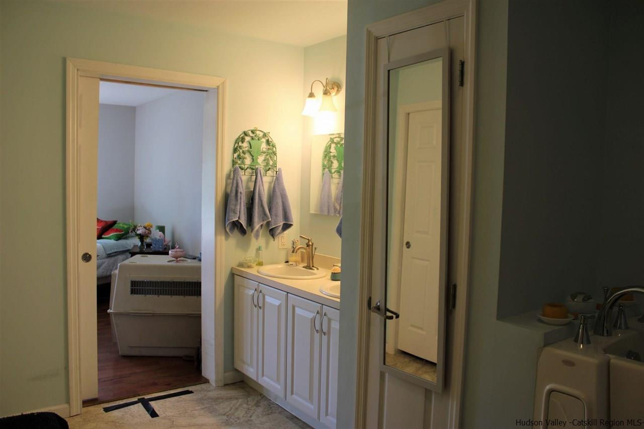 10 Iken Road Kerhonkson, NY 12446 - Photo 12 of 17 a bathroom with a sink a toilet and mirror