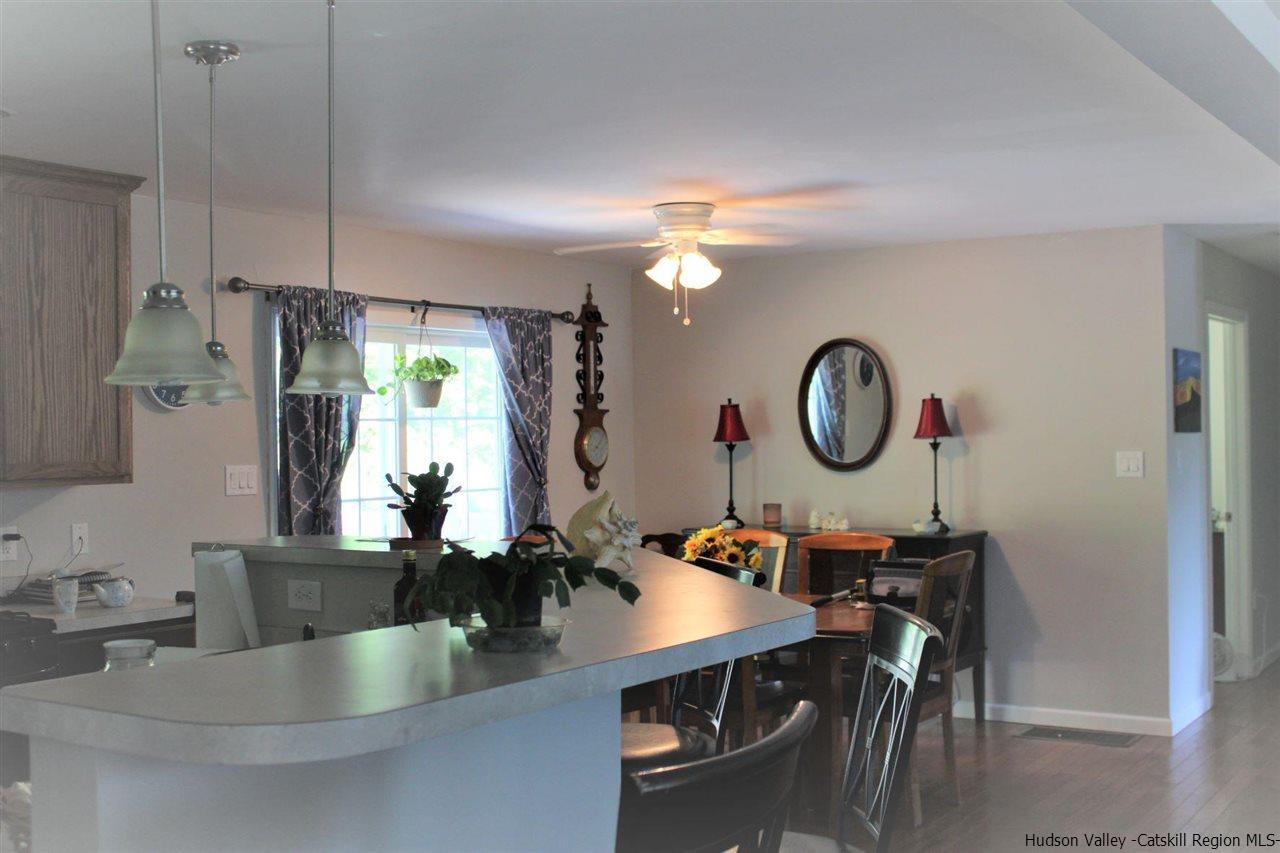 10 Iken Road Kerhonkson, NY 12446 - Photo 14 of 17 a living room with dining table and a large window