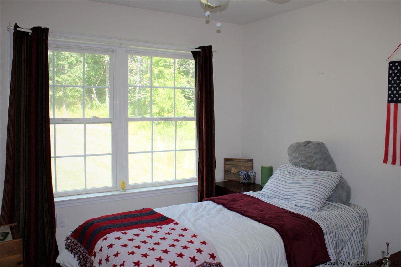 10 Iken Road Kerhonkson, NY 12446 - Photo 17 of 17 a bedroom with a bed and a window