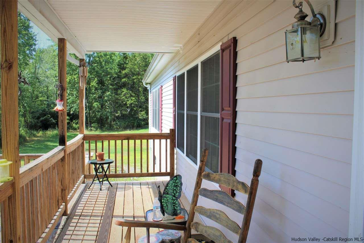 10 Iken Road Kerhonkson, NY 12446 - Photo 3 of 17 a view of balcony with wooden floor and outdoor seating