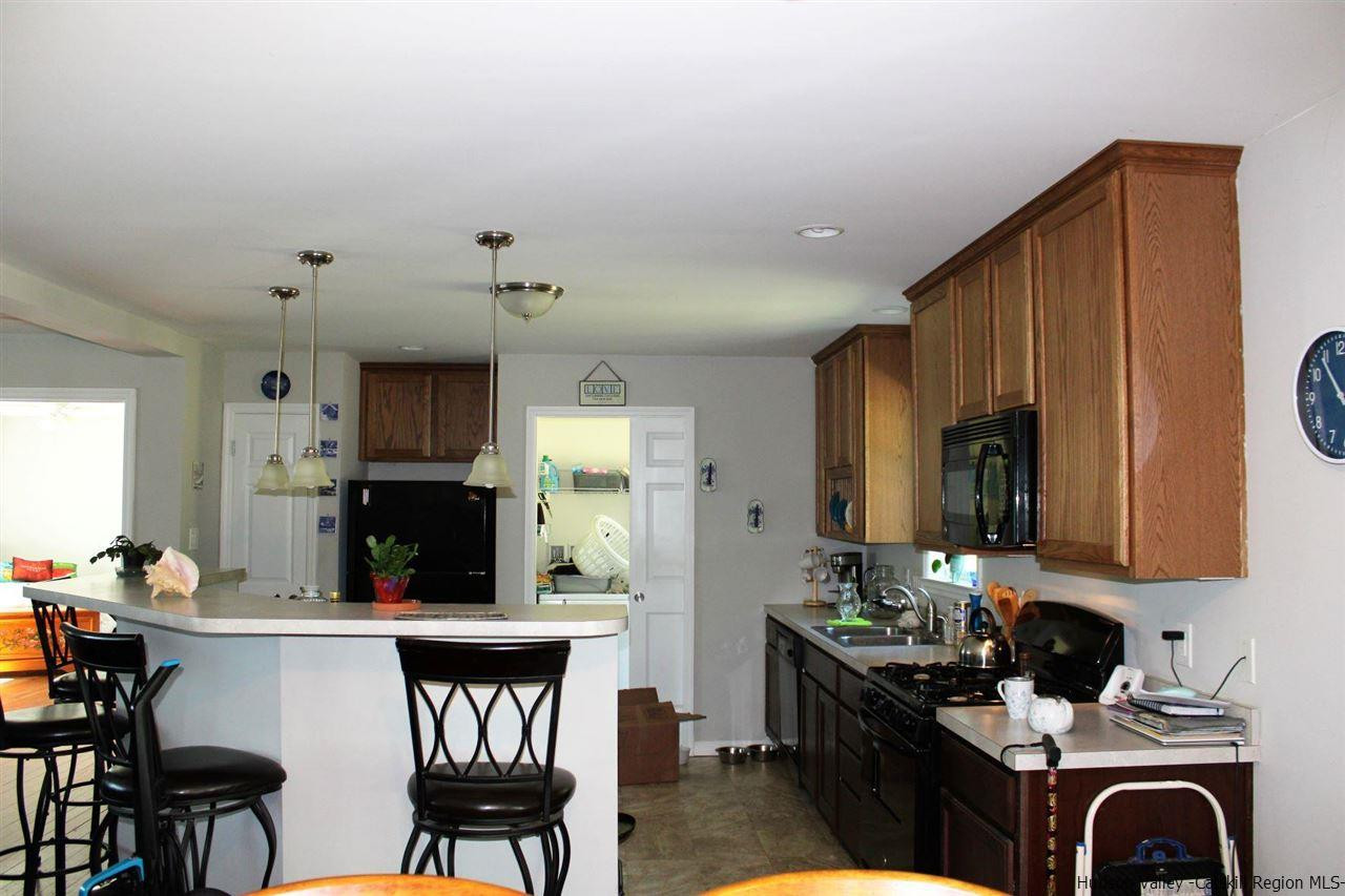 10 Iken Road Kerhonkson, NY 12446 - Photo 6 of 17 a kitchen with stainless steel appliances a sink cabinets and wooden floor