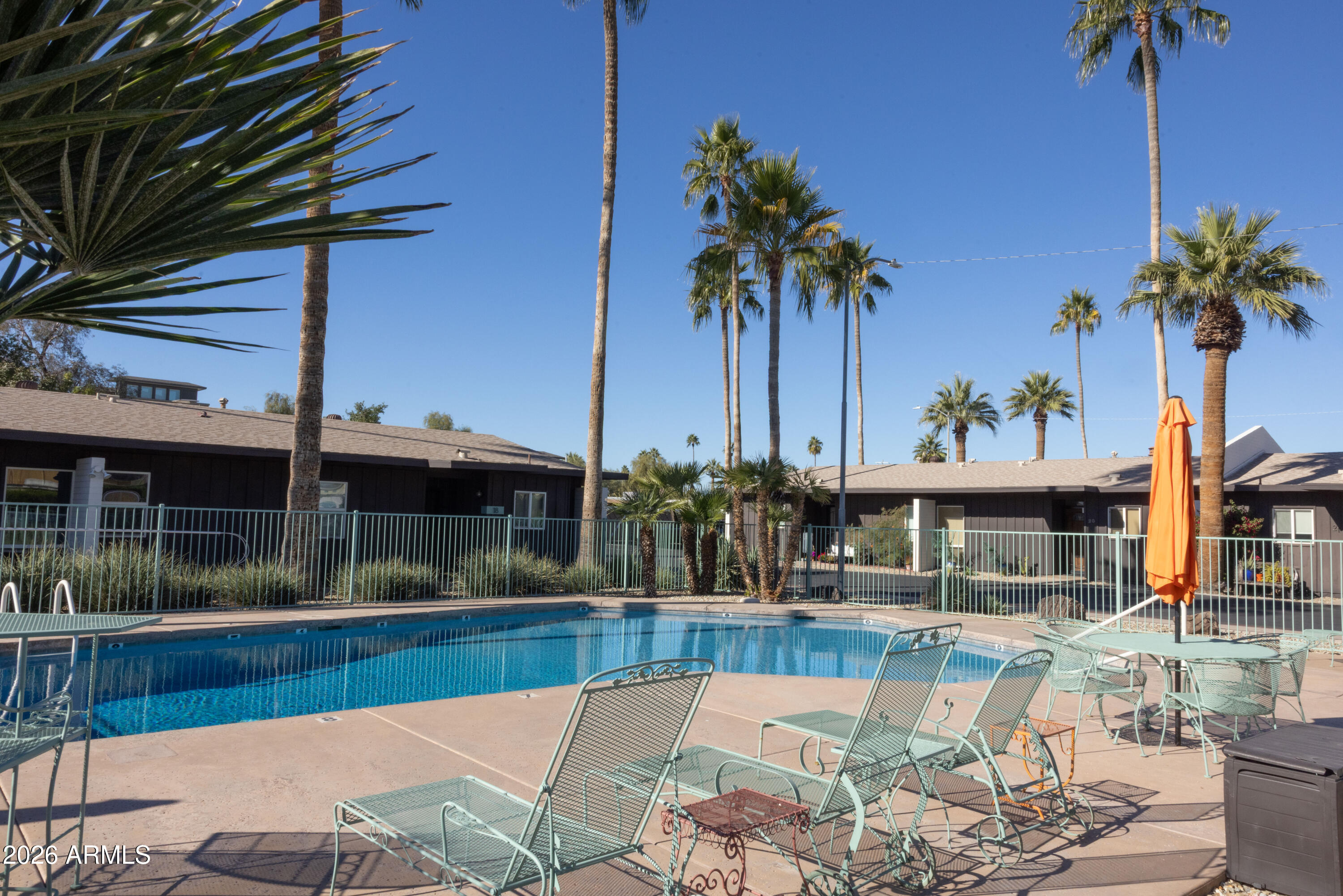 1450 East Bethany Home Road, Unit 31 Phoenix, AZ 85014 - Photo 22 of 24 a view of a swimming pool with a table and chairs