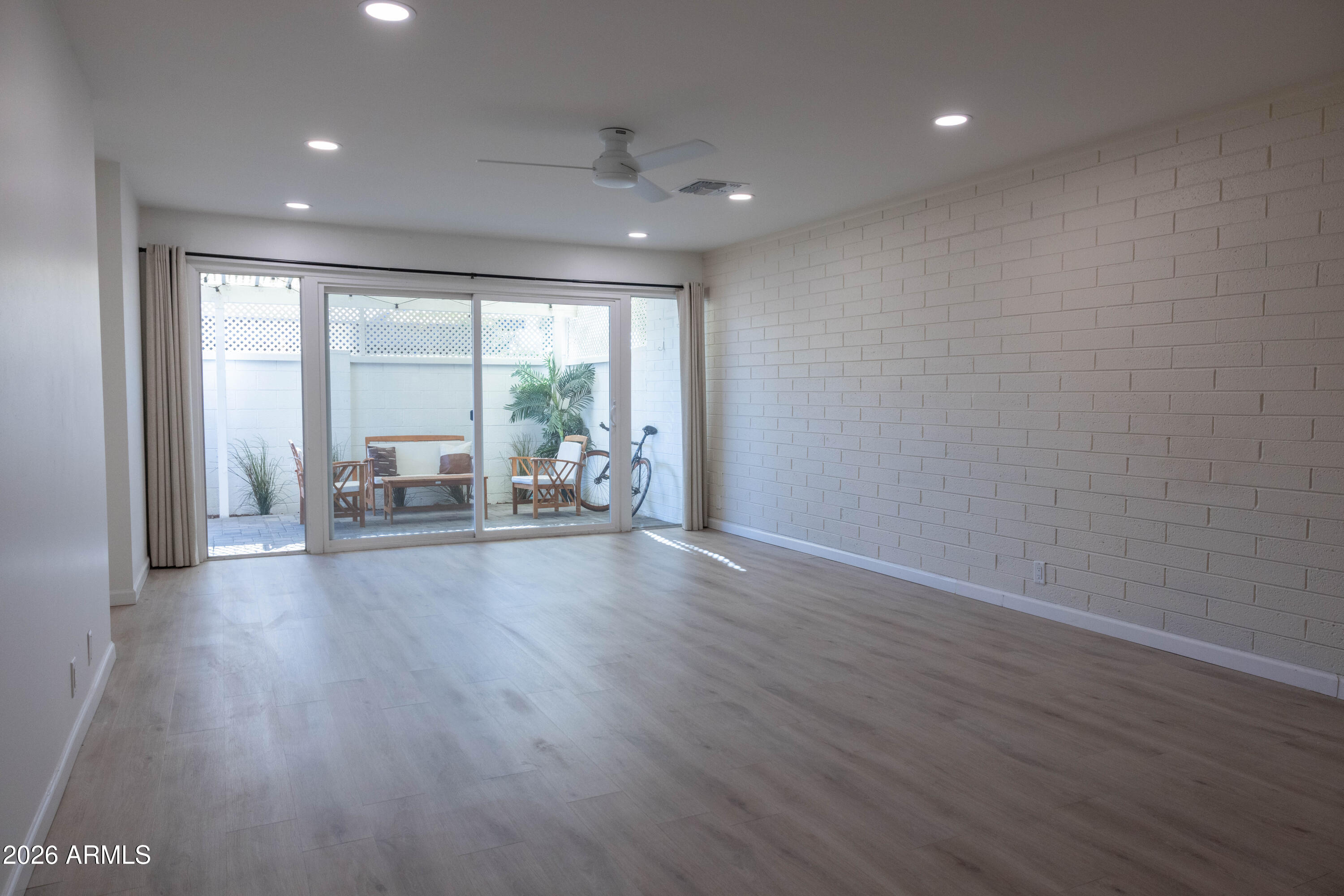 1450 East Bethany Home Road, Unit 31 Phoenix, AZ 85014 - Photo 4 of 24 a very nice looking room with wooden floor and a floor to ceiling window